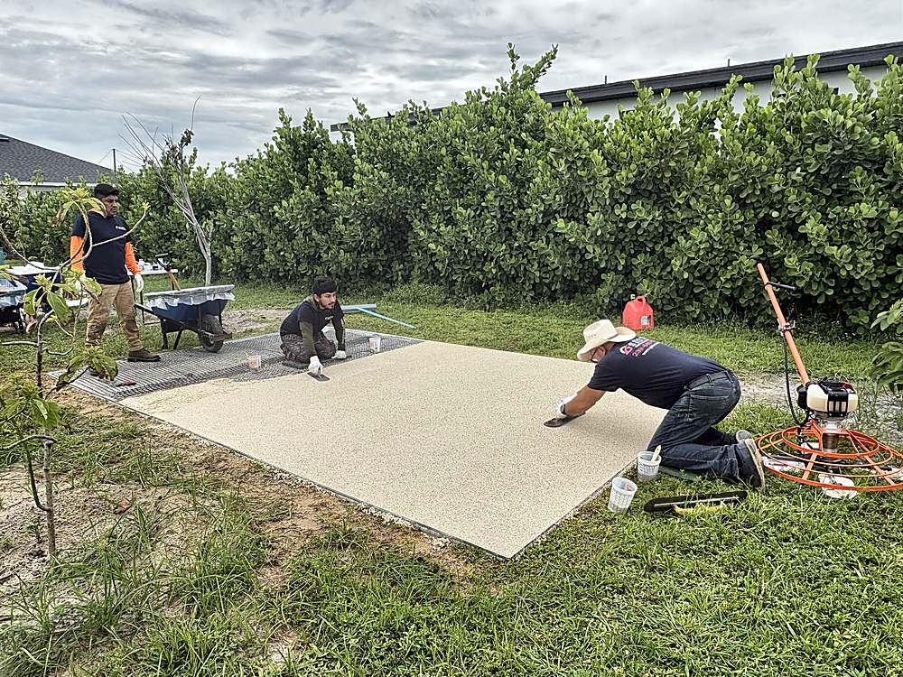 The G Stone crew hand-troweling a new resin-bound stone pad