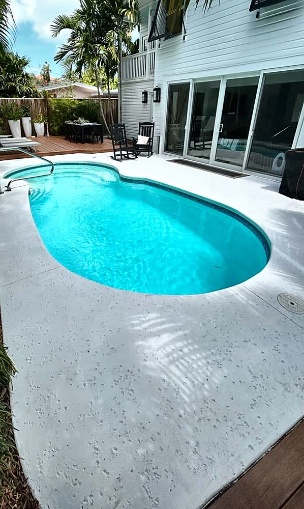 Pool deck before, plain painted concrete