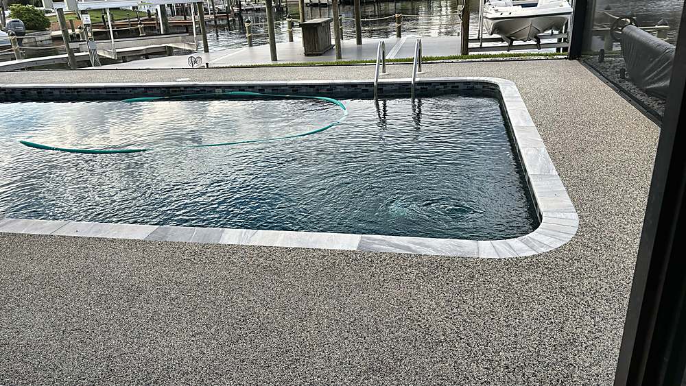 Finished canal-front pool deck in a gray Vuba Stone blend